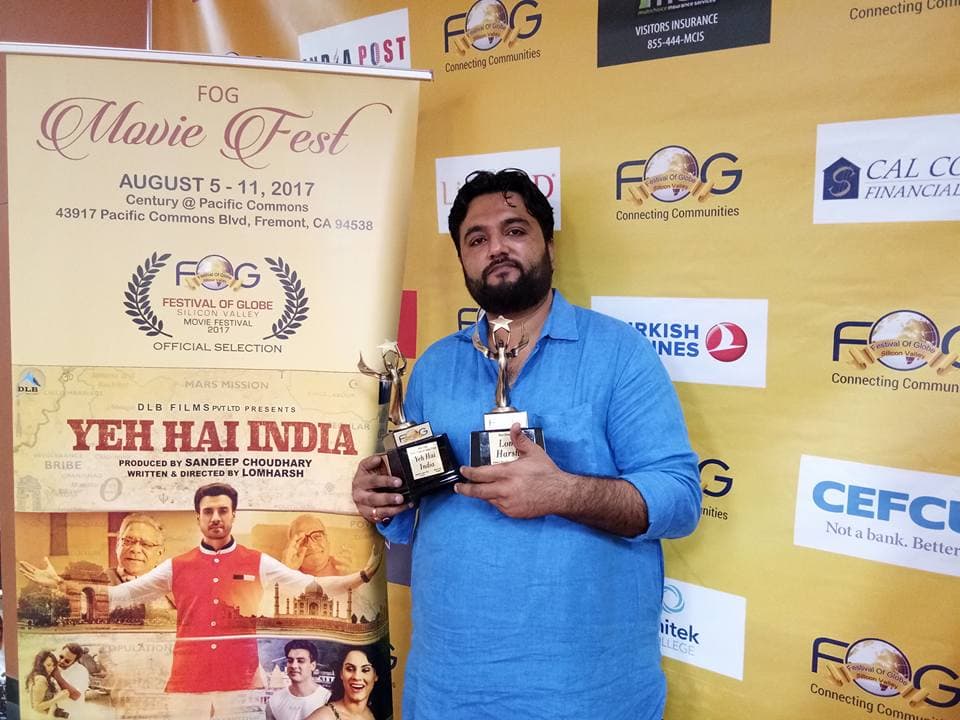 Lom Harsh holding Best Director and Best Film trophies at Festival of Globe USA